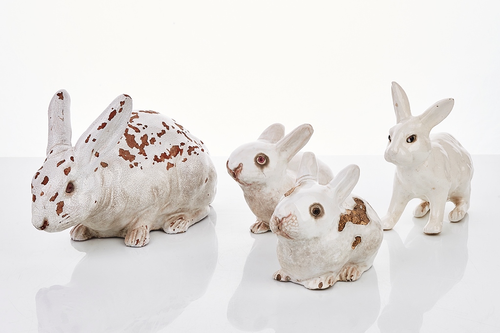 Four White Glazed Terracotta and Ceramic Rabbits - Shapiro Auctioneers